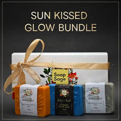 Sun Kissed Glow Bundle with soap bars and a box on a dark background